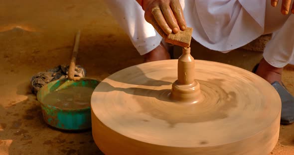 Skilled Hands of Potter Shaping the Clay on Potter Wheel and Sculpting Clay Pot Jar. Shilpagram