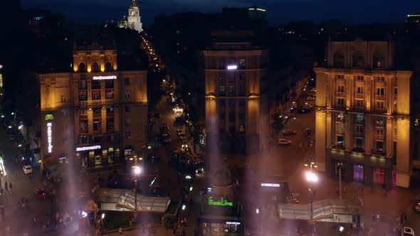 Aerial View of Night City with Colored Splashing Fountains