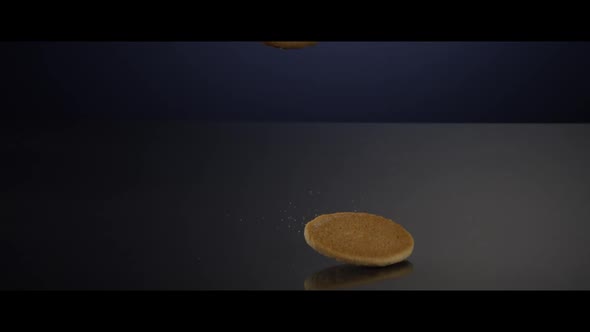 Falling cookies from above onto a reflective surface - COOKIES 234
