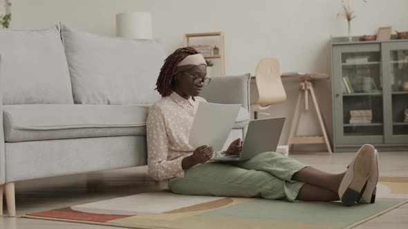 Young Female Freelancer Working in Living Room