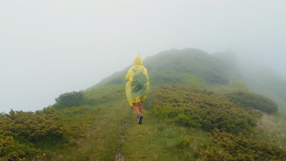 Dull landscape view and woman wearing yellow raincoat no landscape in the mountains.