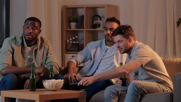 Happy Male Friends with Beer Watching Tv at Home