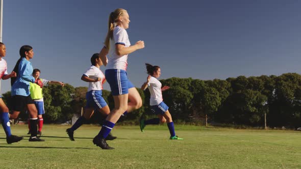 Female soccer team running while team captain gives instructions. 4k