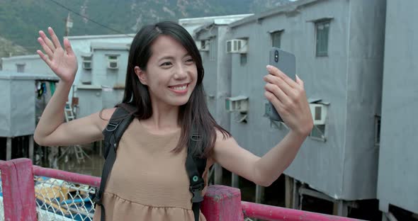 Woman take photo on cellphone in Tai O village