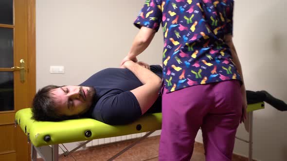 joint therapy with physiotherapist and patient on a stretcher