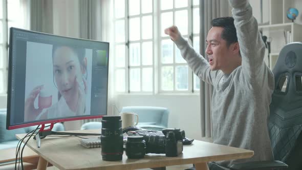 Asian Cameraman Being Happy Finishing Editing Photos By Desktop Computer While Working At Home