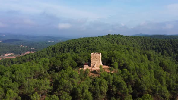 aerial drone shot of soldiers tower in avinyó dense natural green forest. mountains of catalonia spa