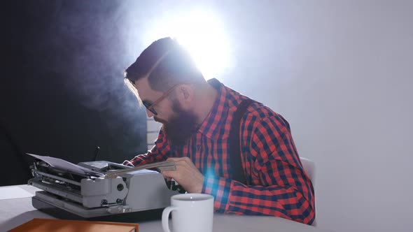 Retro Writer Concept. Young Bearded Stylish Man Writing on Old Typewriter