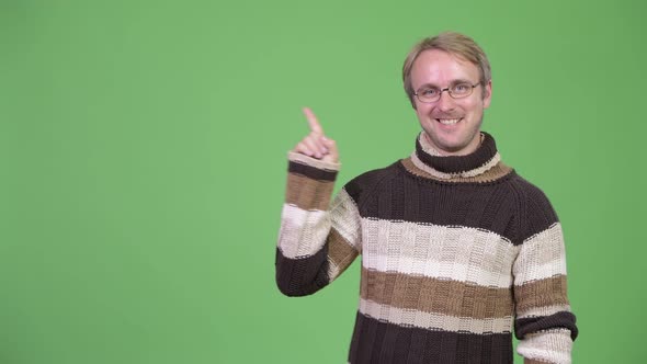 Studio Shot of Happy Handsome Man Pointing Up