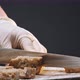 Woman Cuts Slices of Tasty Fresh Rye Bread on Wooden Board - VideoHive Item for Sale