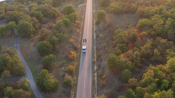 A Truck With A Platform Passes On The Road With Flashing Special Lights