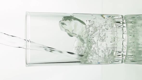 Vertical Video Crystal Clear Water Pouring Into Glass