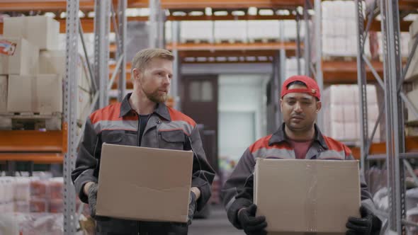 Warehouse Workmen Walking With Boxes