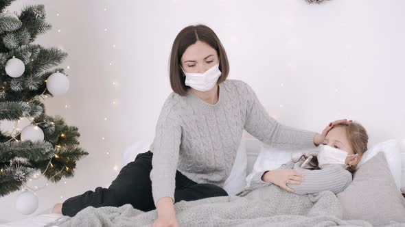 Mother and Ill Child in Bed During New Year Holidays