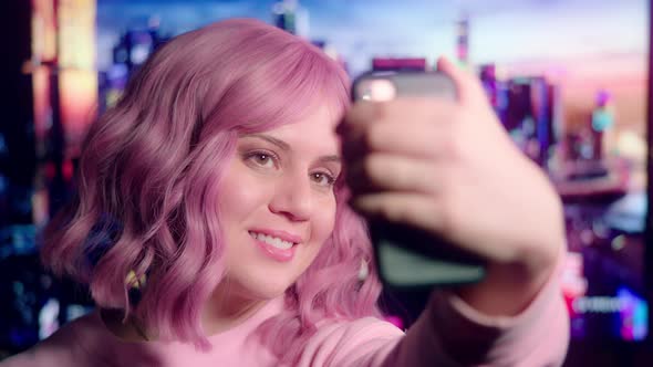 Pink-Haired Party Girl Takes Selfies on Smart Phone with Colorful Sci-Fi Scene in Background