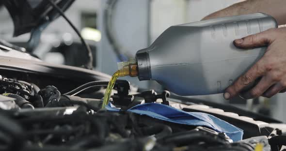 Car Service Worker Changes Oil In The Car