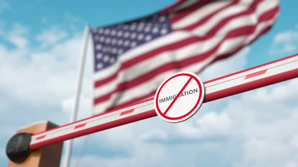 Opening Barrier with Stop Immigration Sign Against the American Flag