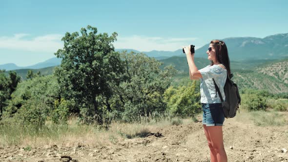 Professional Female Photographer Taking Picture Standing at Beautiful Nature Park