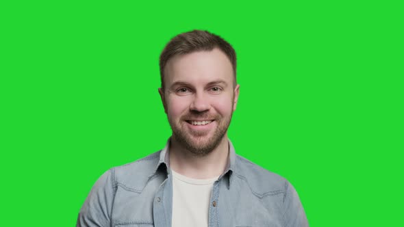 Handsome Man Smiling and Looking at Camera. Portrait of Guy at Green Screen