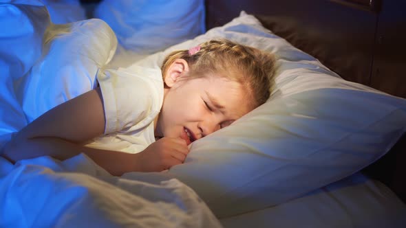 A Sweet Little Girl Naps in Bed Sees a Nightmare and Winces in Sleep