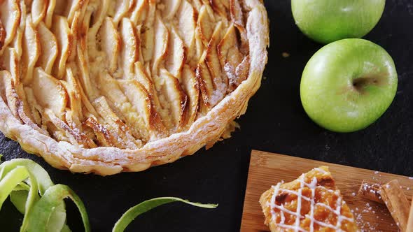 Tart and apple on concrete background