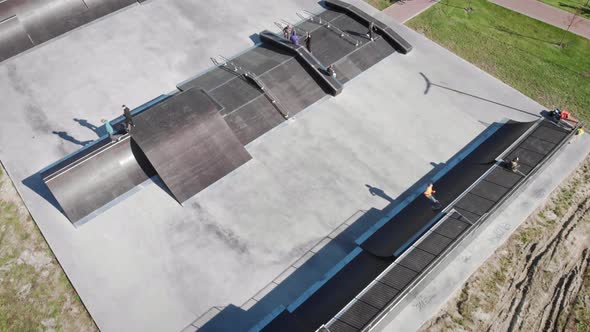 Aerial drone view of skate park with skateboarders