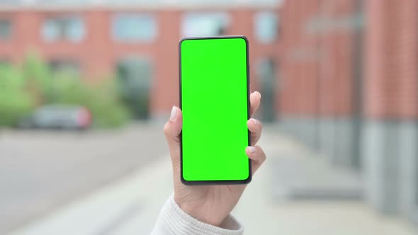 Woman Holding Smartphone with Green Chroma Screen