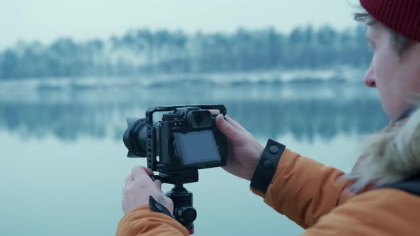 Hiker Taking Pictures of Snowy Nature in Winter Lake Background Winter Forest