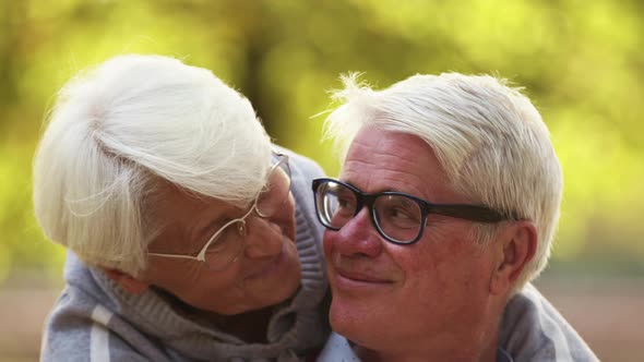 Happy Senior Caucasian Couple Smiling to Each Other Holding Hands Selective Focus on Faces Look at