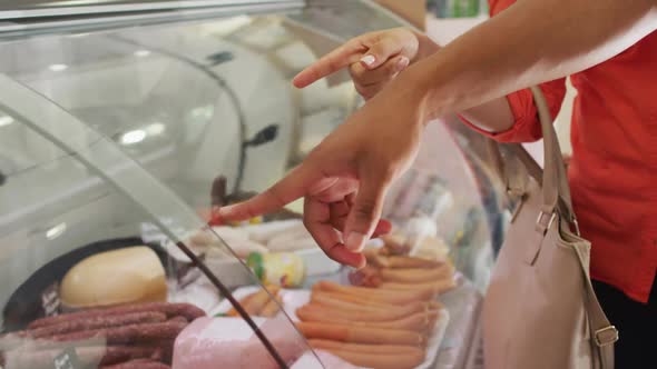 Video of hands of diverse female and male customers choosing food