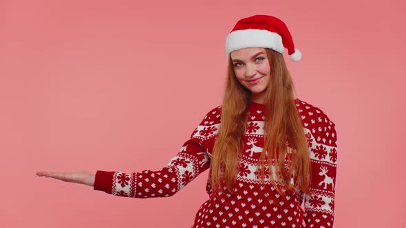 Woman Wears Red New Year Sweater Deer Showing Thumbs Up and Pointing at on Blank Advertisement Space