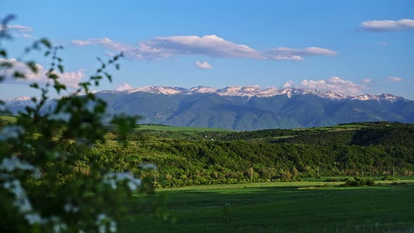 Rila Mountain, Bulgaria Landscape. Green Hills, Snow Peaks, Pink Clouds at Sunset. Time Lapse