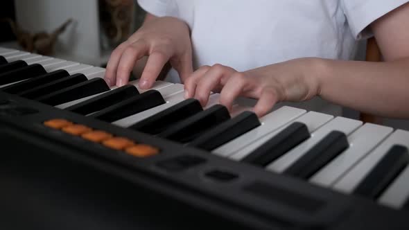 Boy Playing Synthesizer at Home