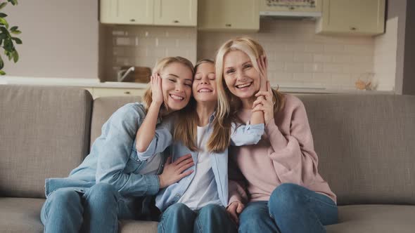 Portrait of Three Generations of Women Look at Camera Posing for Family Picture Cute Little Girl Hug