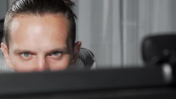 Sliding Cropped Shot of a Male Eyes Looking at Computer Monitor