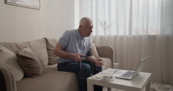 Pensioner Measuring Blood Pressure During Online Appointment