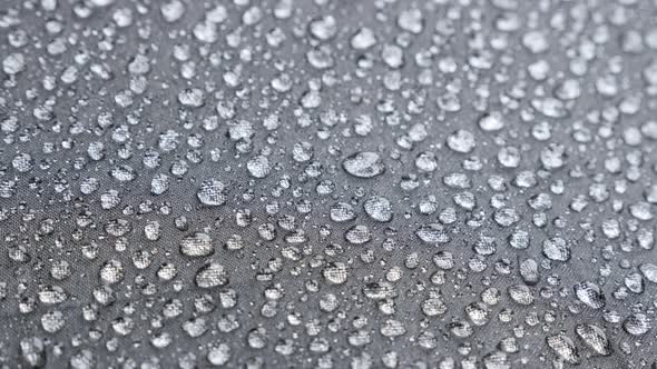 Texture of water-resistant material with many raindrops close-up 4K 2160p 30fps UltraHD  video - Bla