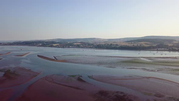 Sky view of historic town in Southwest England. The town is visible in the distance with lushes hill