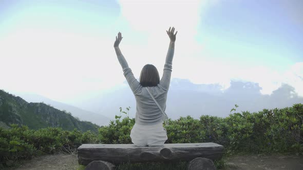 Portrait of Woman Outstretching Their Arms at Top of Mountain. Summer Adventure Journey Nature