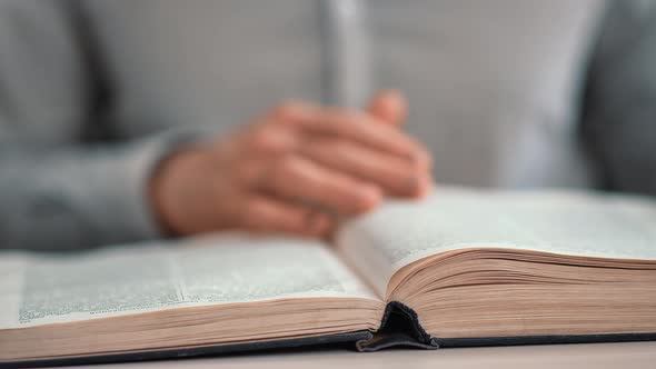 Closeup Unrecognizable Male Reading Vintage Book Turning Paper Pages on Desk at Public Library