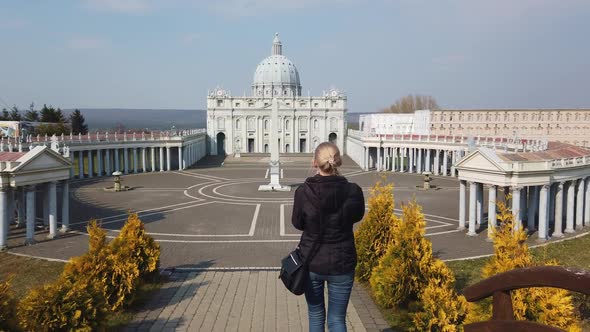 Female Makes Photo Walking on Foot Near a Miniature Model of the Saint Peter's Basilica, Vatican