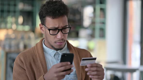 African Man Excited By Online Shopping on Smartphone