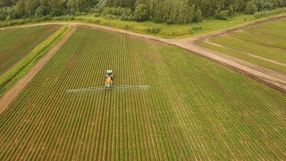 Tractor Is Spraying Fertilizers Field