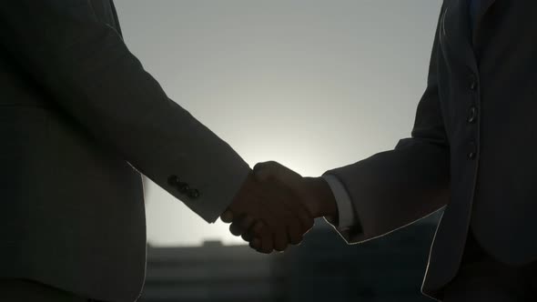 Closeup Shot of People Shaking Hands on Street