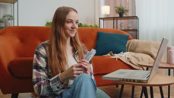 Smiling Happy Young Woman Counting Money Cash and Use Laptop Pc Calculate Domestic Bills at Home