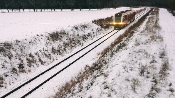 Suburban train on the railroad in winter