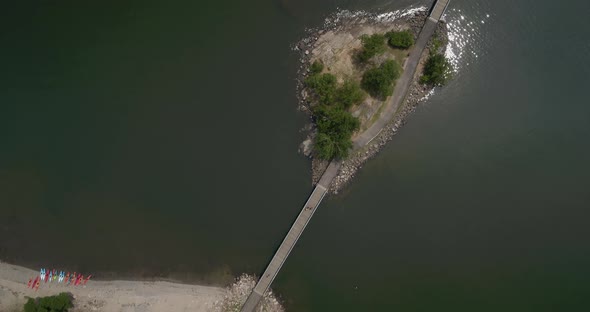 Top Down Aerial Panning View of a Small Bridge Over Water