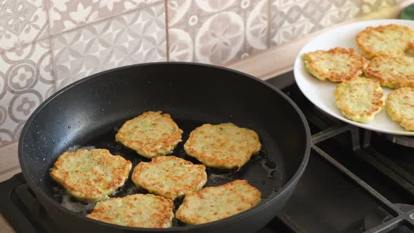 Cooking vegetable pancakes in a frying pan. Fry pancakes, fried golden crust pancakes.