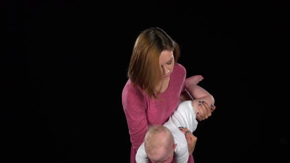 Family Mother and a Small Child Playing. Black