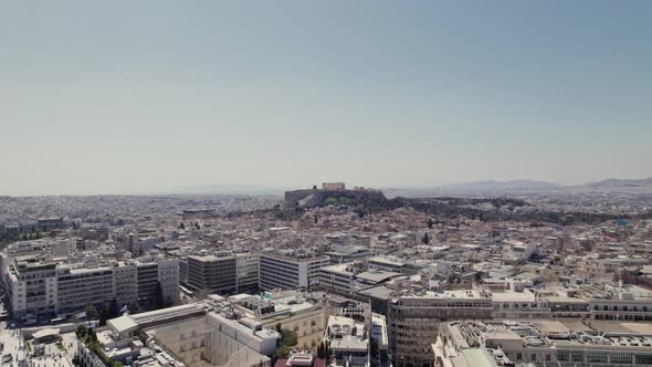 Aerial shot of Athens, Greece city center with view of Acropolis in the background during midday day